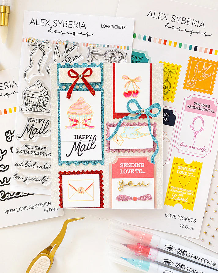 Collection of Alex Syberia designs cards and stamps on a white background with markers.