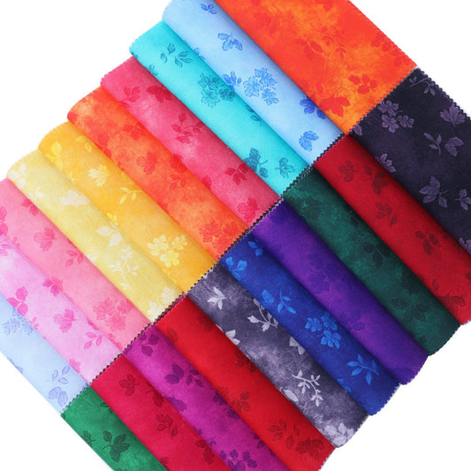 Colorful fabric swatches arranged in a grid pattern on a white background
