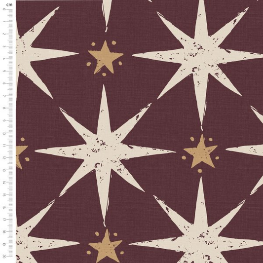 Fabric with star pattern on a brown background, featuring a ruler for scale.