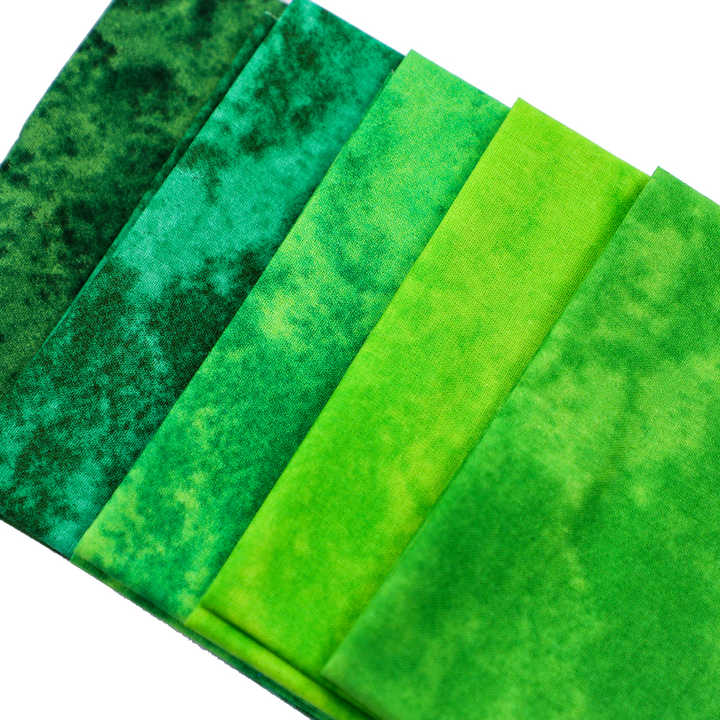 Set of green fabric swatches arranged in a row on a white background