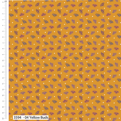 Patterned fabric with small white dots and purple shapes on a yellow background, with a ruler for scale.