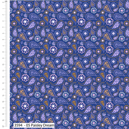 Patterned fabric with paisley and floral designs on a blue background, with a ruler on the left side.