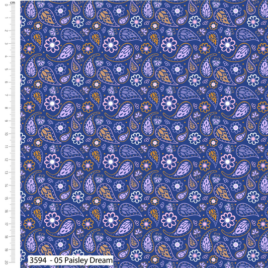 Patterned fabric with paisley and floral designs on a blue background, with a ruler on the left side.