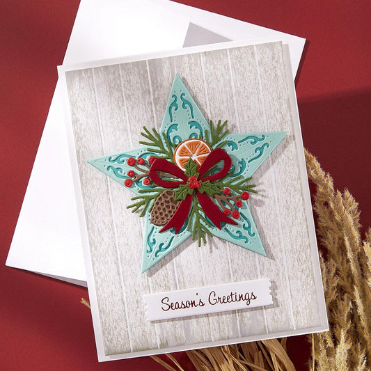 Christmas card with star design, bow, and foliage on a wooden-textured background.