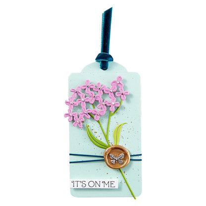 Decorative tag with pink floral design, green leaves, and a butterfly emblem on a light blue background.