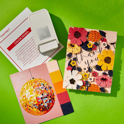 Color wheel, educational card, and floral-themed card on a green background