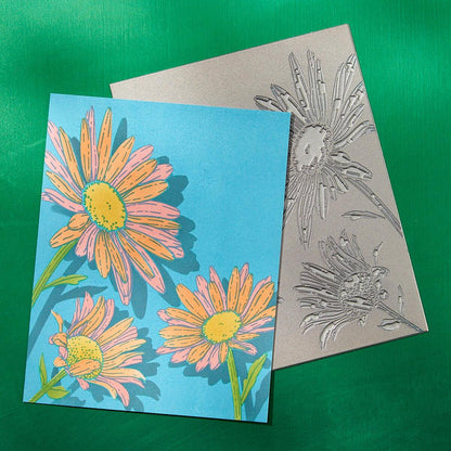Colorful floral card with embossed matching design on a green background
