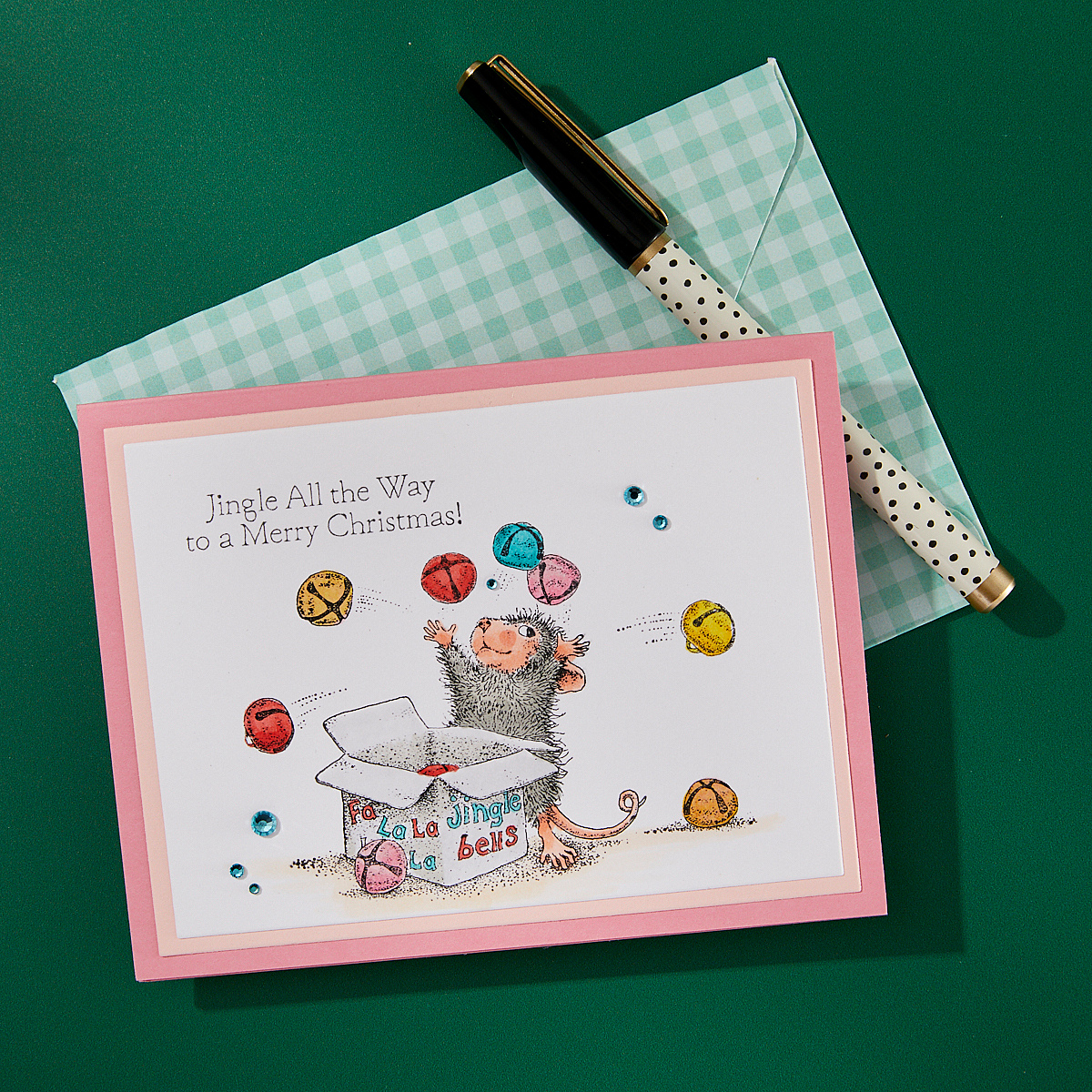 A finished Christmas card featuring a stamped design from the Spellbinders Jingle Bell Wishes stamp set.