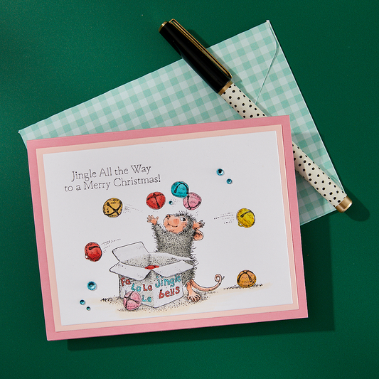 A finished Christmas card featuring a stamped design from the Spellbinders Jingle Bell Wishes stamp set.