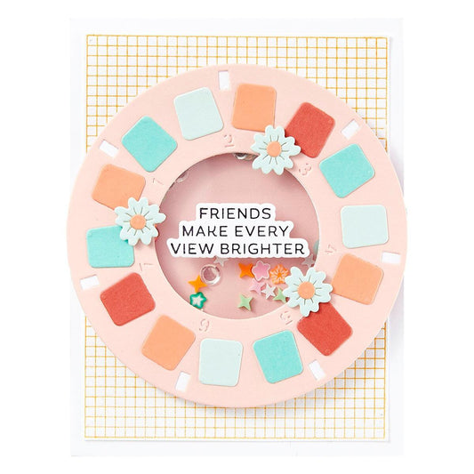 Decorative wreath with colorful squares and flowers on a yellow grid background