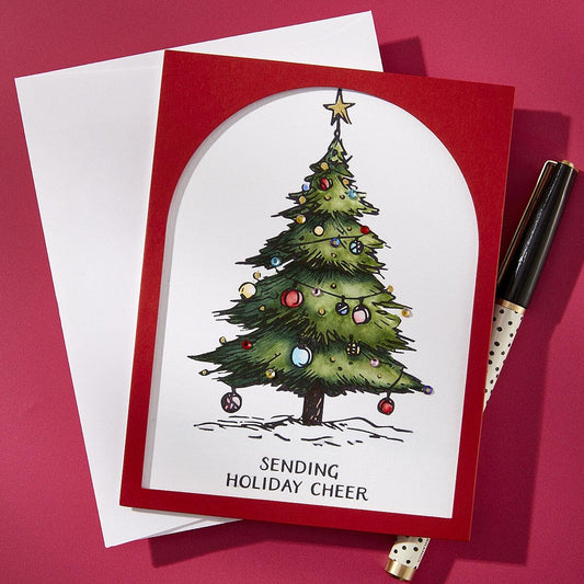 Christmas card with a decorated tree and 'Sending Holiday Cheer' text on a red background.
