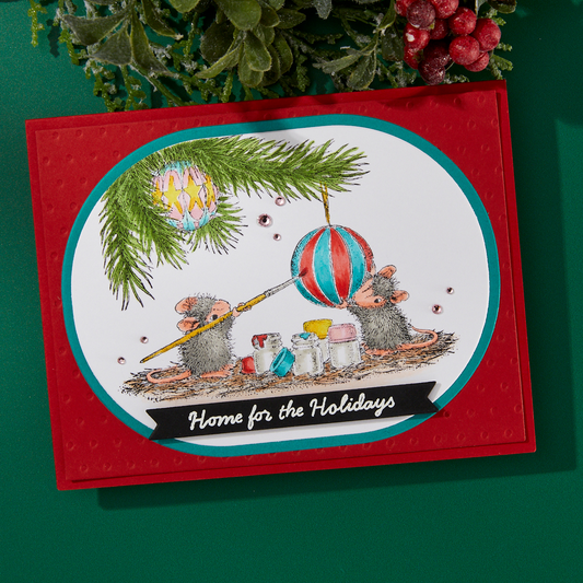 A finished Christmas card featuring a stamped design from the Spellbinders Unwrapping Memories stamp set.