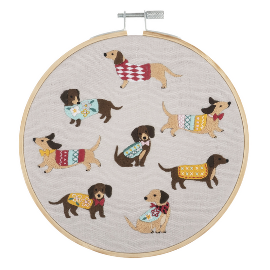 A finished handmade embroidery hoop with a dog design created with the kit.