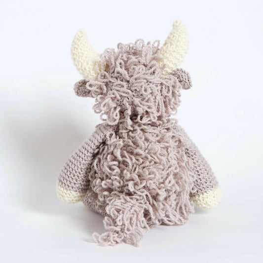 Knitted toy with horns on a white background