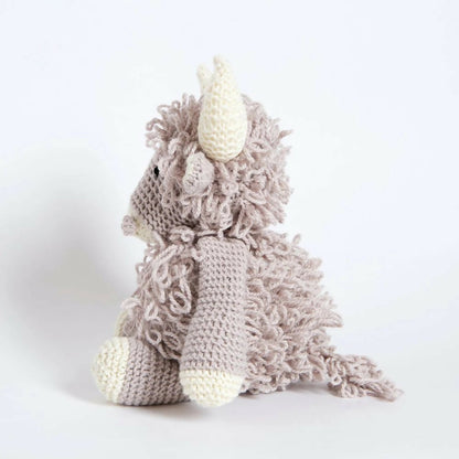 Knitted cow toy on a white background