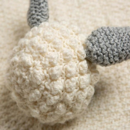 Close-up of a textured white ball with gray accents on a beige background