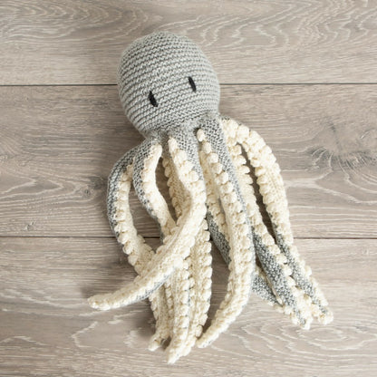 Knitted octopus toy on a wooden surface