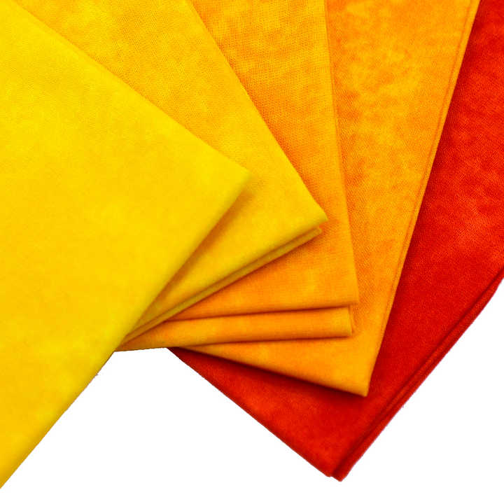 Stack of yellow, orange, and red fabric swatches on a white background