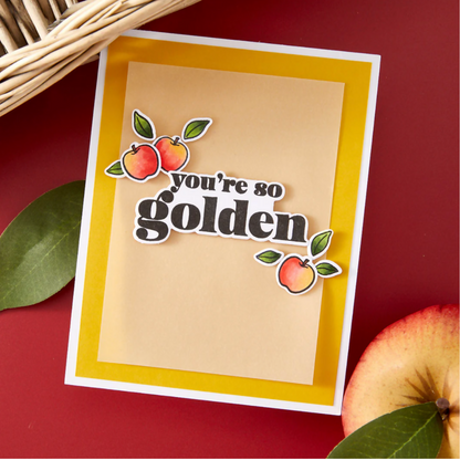 Card with 'you're so golden' text and apple illustrations on a red background