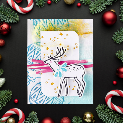 Christmas card with a deer design surrounded by festive decorations on a dark background