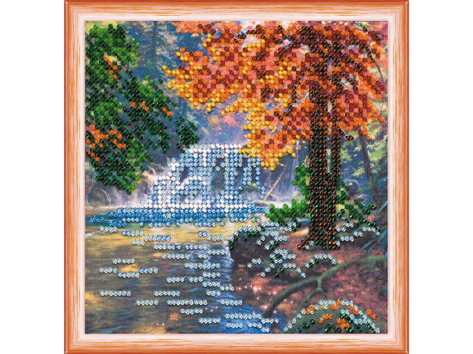 Embroided scene with autumn tree, bridge, and water body.