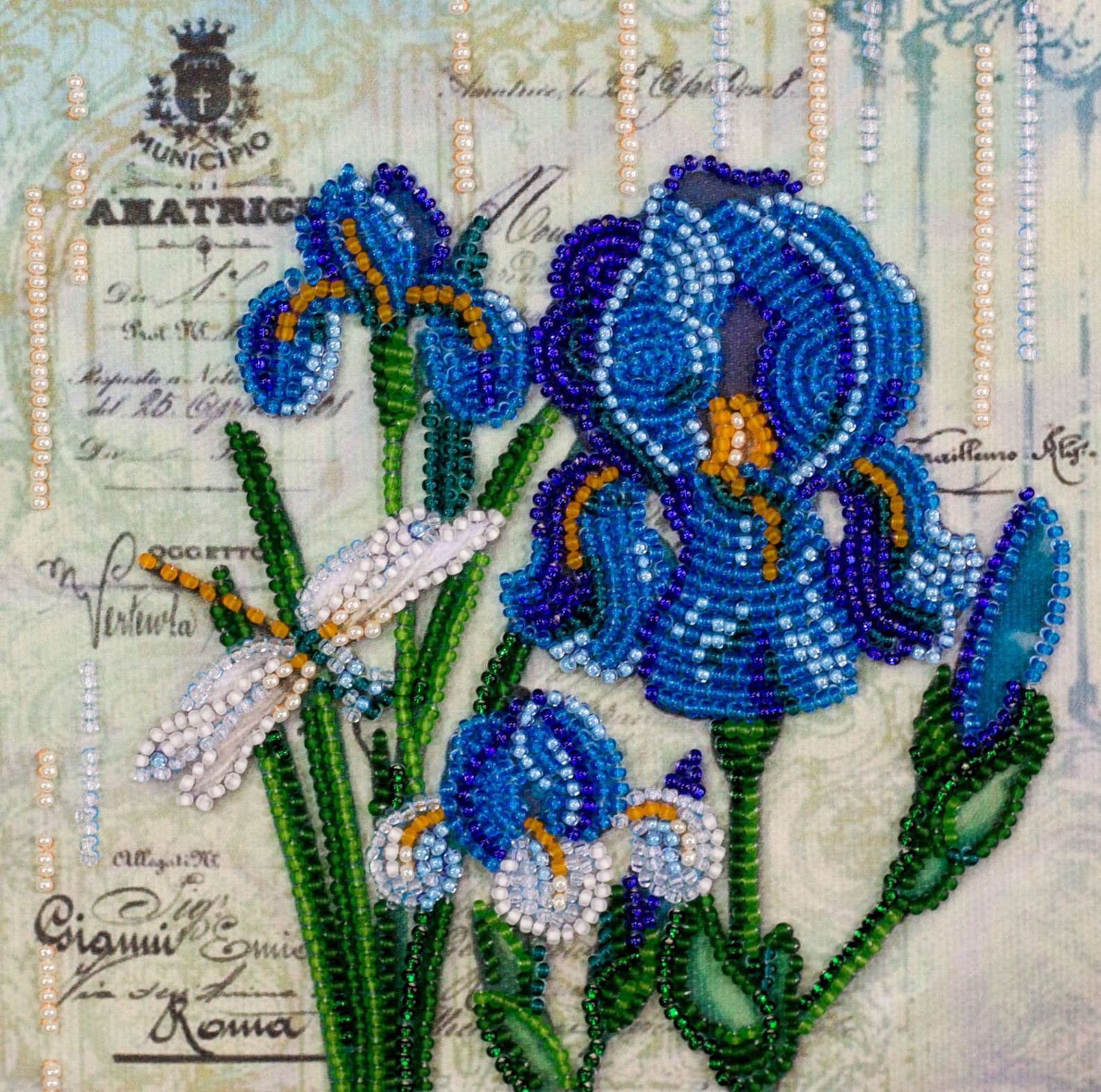 Decorative artwork of blue flowers with beadwork on an old letter background