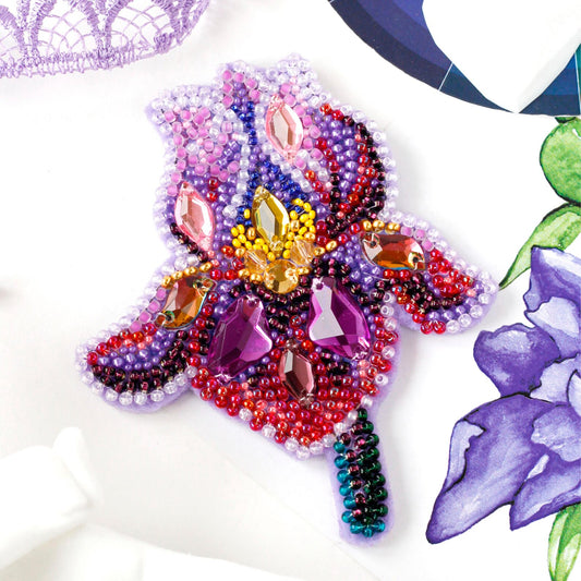 Colorful beaded design of a flower on a white background