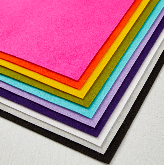 Stack of colorful felt sheets in various colors on a white background