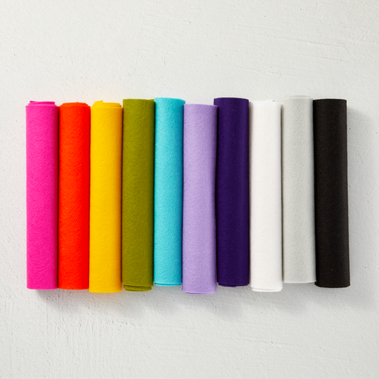 Row of colorful cylindrical objects on a white background