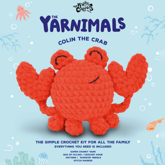 Crocheted crab toy with 'The Yarnimals' branding on a light blue background