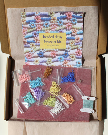 Beaded daisy bracelet kit with colorful beads and packaging in a cardboard box.