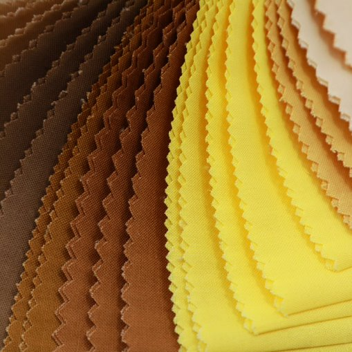Stack of fabric swatches in brown and yellow colors