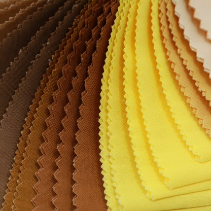 Stack of fabric swatches in brown and yellow colors